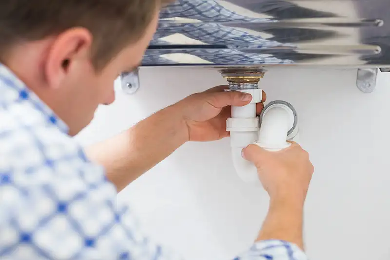 Plumber cleaning a drain
